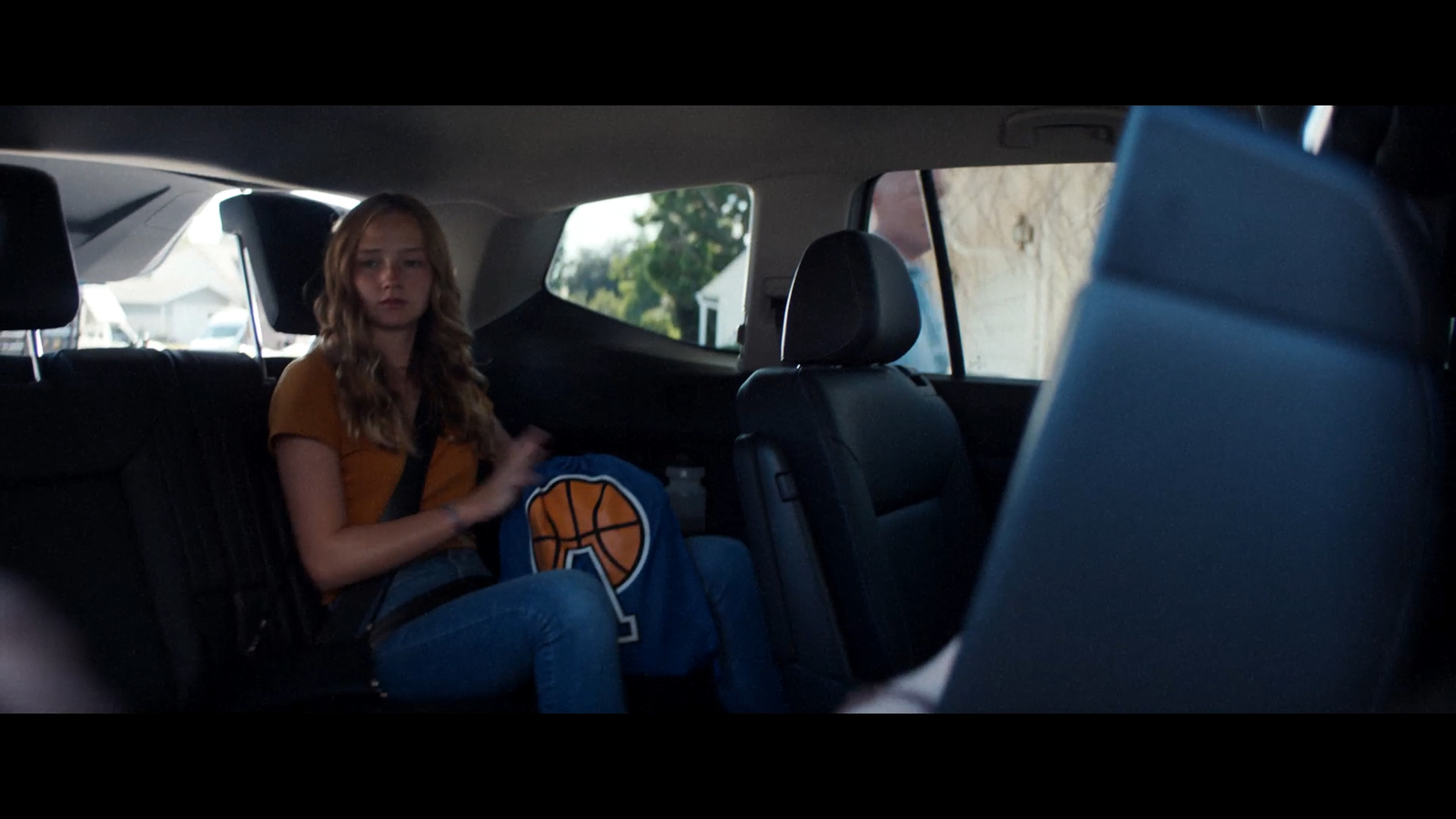 a woman sitting in the back seat of a car