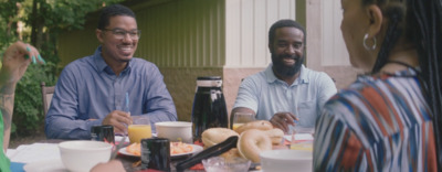 a group of people sitting around a table eating food