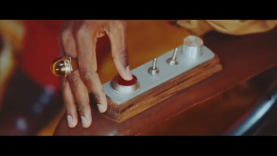 a person touching a button on a wooden table