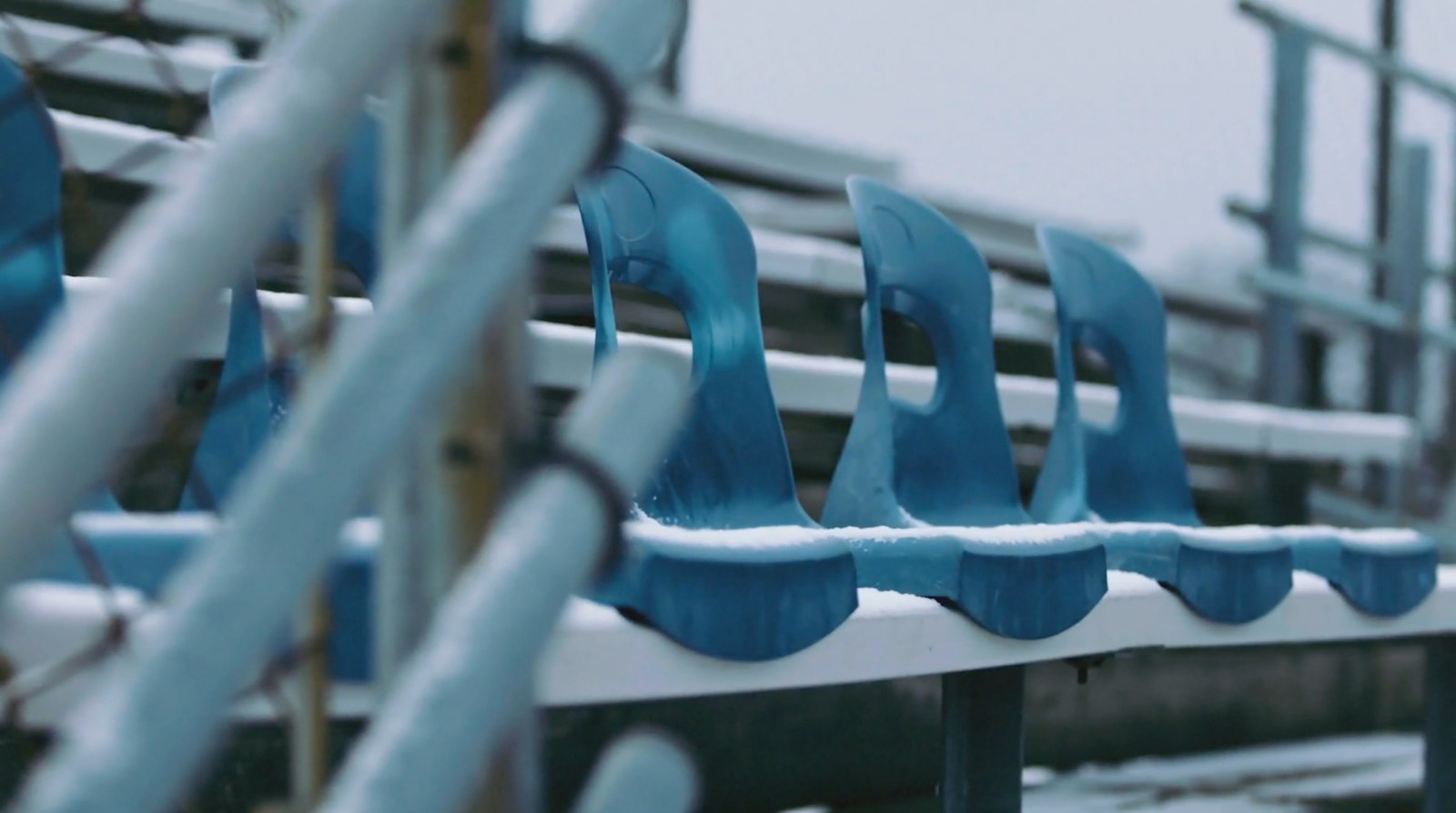 a row of blue seats sitting next to each other