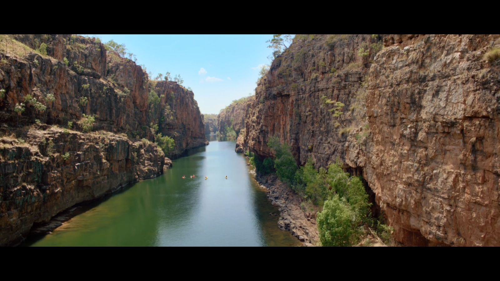 a body of water surrounded by rocky cliffs