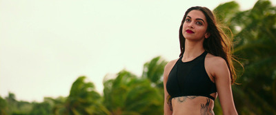 a woman in a bikini top with a tattoo on her chest