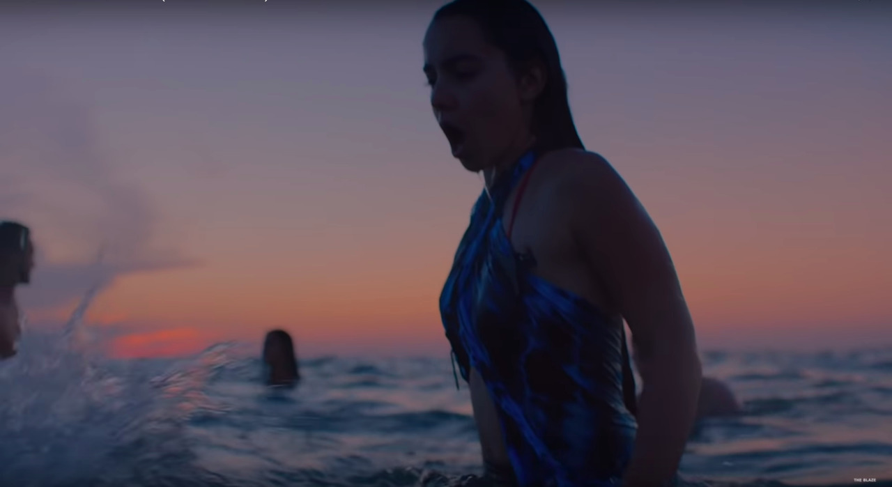 a woman in a bathing suit standing in the water