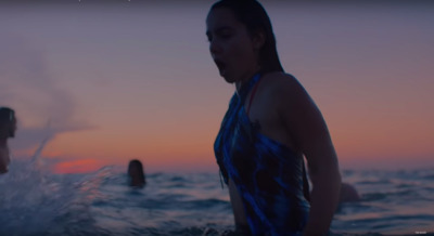 a woman in a bathing suit standing in the water