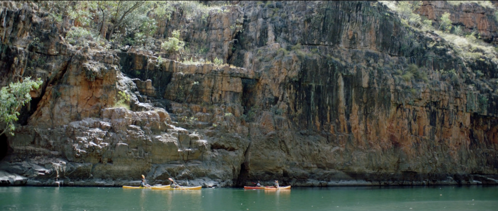 a group of people in canoes on a river