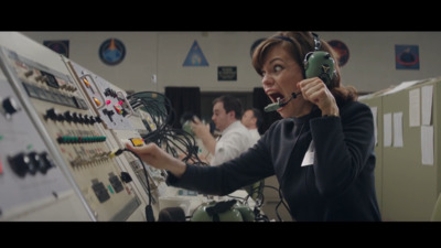 a woman wearing a headset is working on a control panel