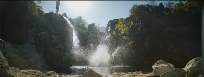 a large waterfall is coming out of the rocks