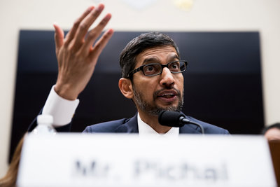 a man in a suit and tie giving a speech