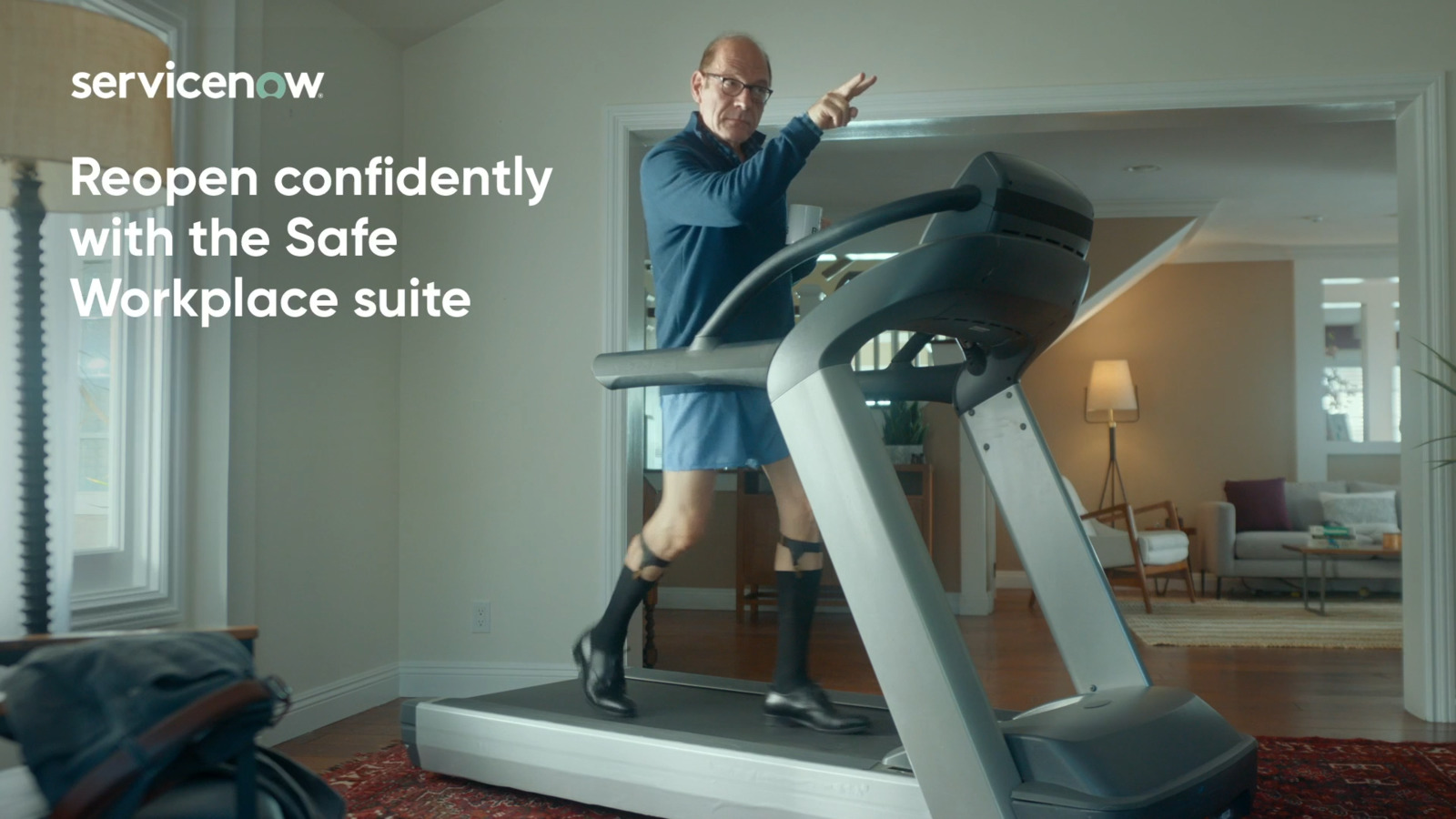 a man standing on a treadmill in a living room