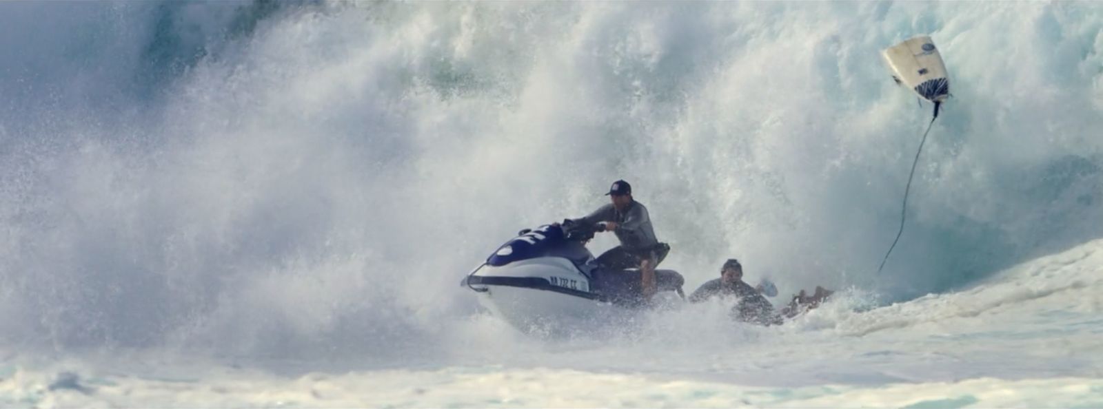 a man riding a jet ski while being pulled by a boat