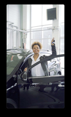 a woman in a car holding a car key