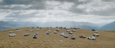 a bunch of cars that are sitting in the dirt