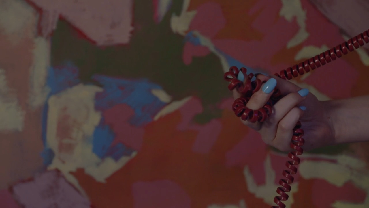 a woman holding a red beaded necklace in her hand