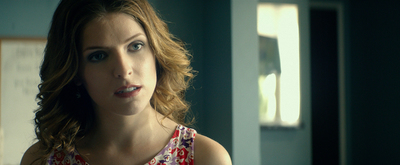 a woman in a red and white dress looking at the camera