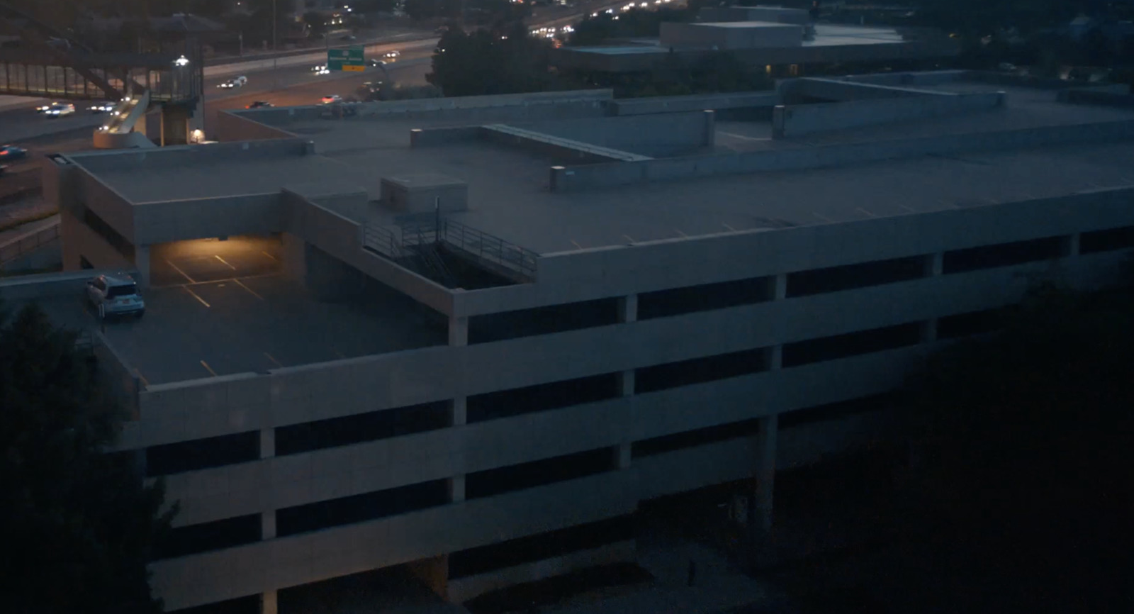 an aerial view of a parking garage at night