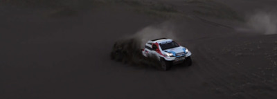 a white truck driving down a dirt road