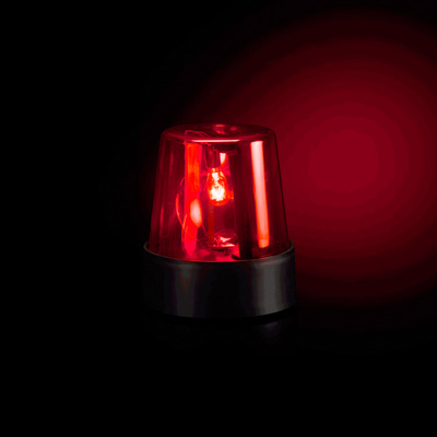 a red light sitting on top of a black table