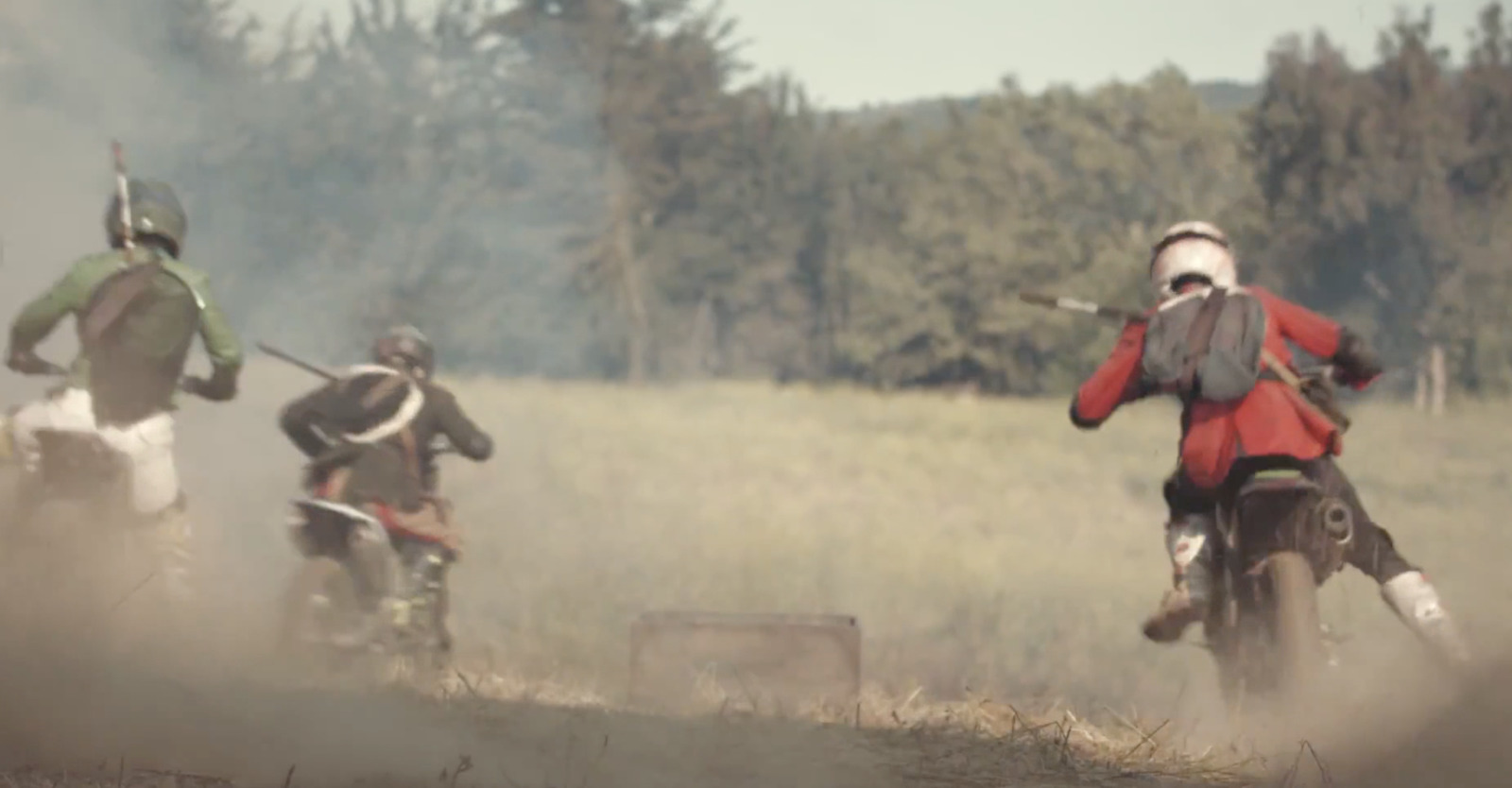 a group of people riding on the back of dirt bikes