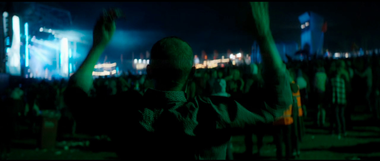 a man standing in front of a crowd at a concert