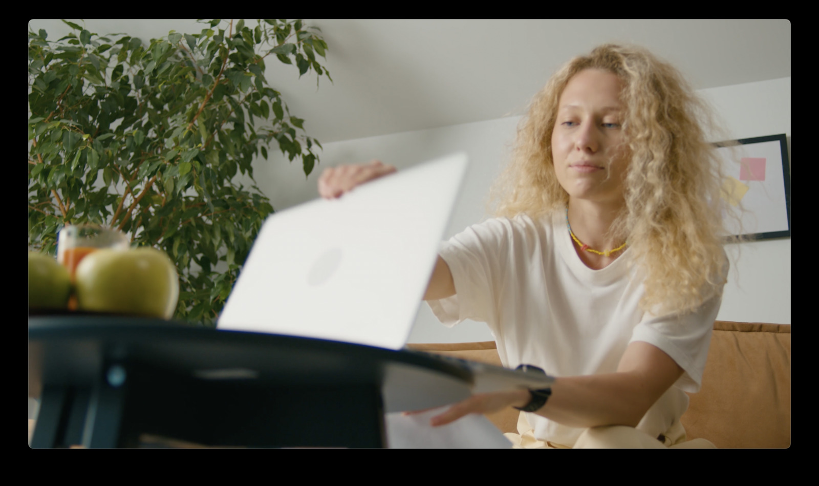 a woman sitting at a table with a laptop computer