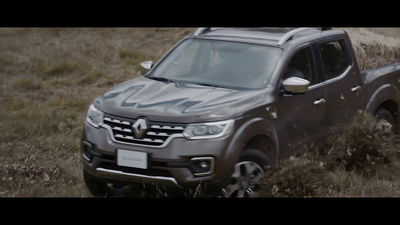 a grey pick up truck driving through a field