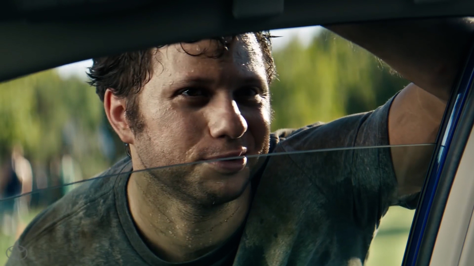 a man looking out the window of a car