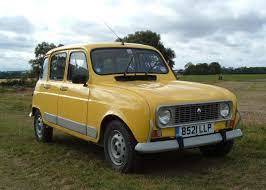 a small yellow truck parked in a field