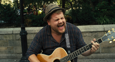 a man with a hat playing a guitar