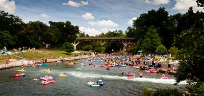 a river filled with lots of people riding in inflatables