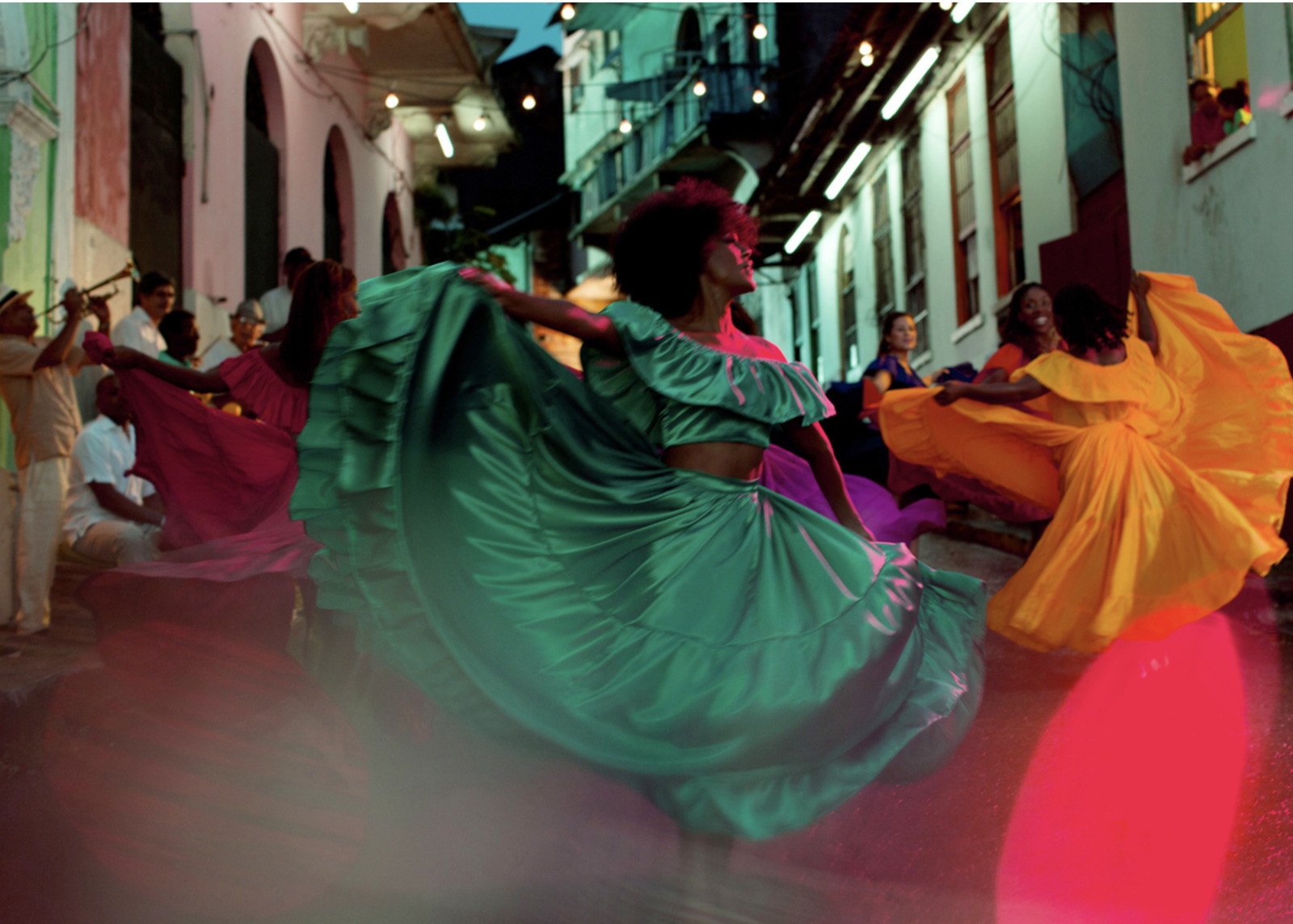 a group of people dancing in a street