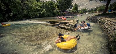 a group of people riding in rafts down a river