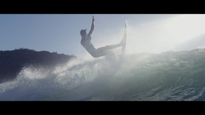 a man riding a wave on top of a surfboard