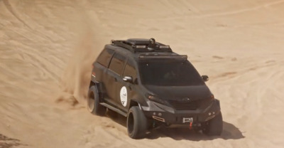 a vehicle driving through the sand in the desert