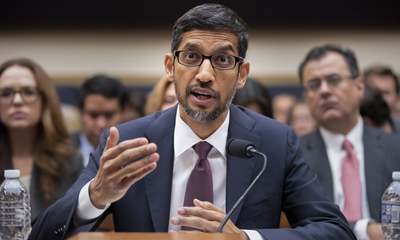 a man sitting at a table with a microphone in front of him