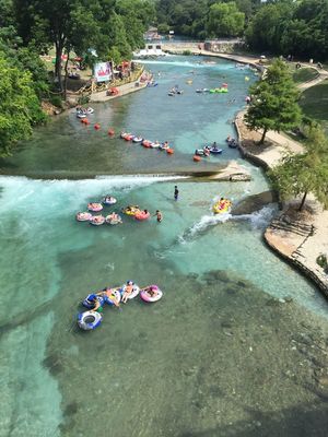 a river filled with lots of people on rafts