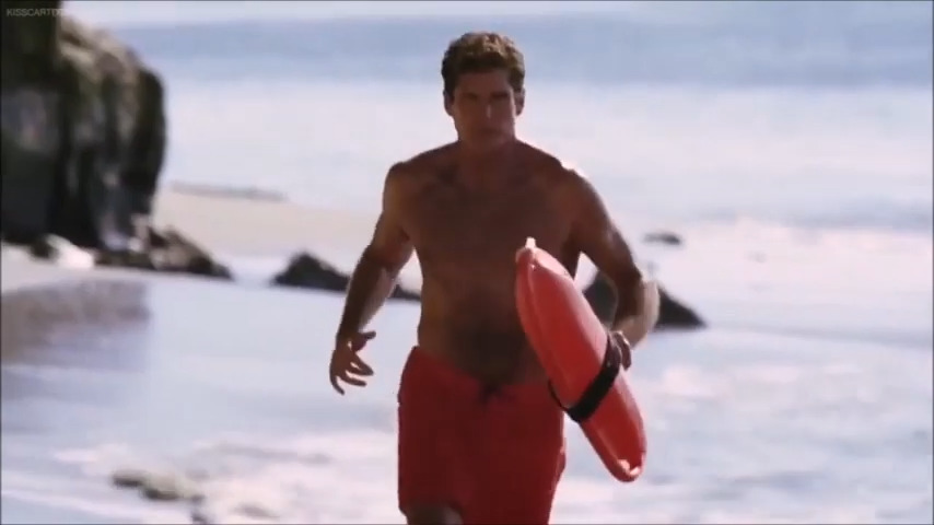 a man walking on the beach with a surfboard