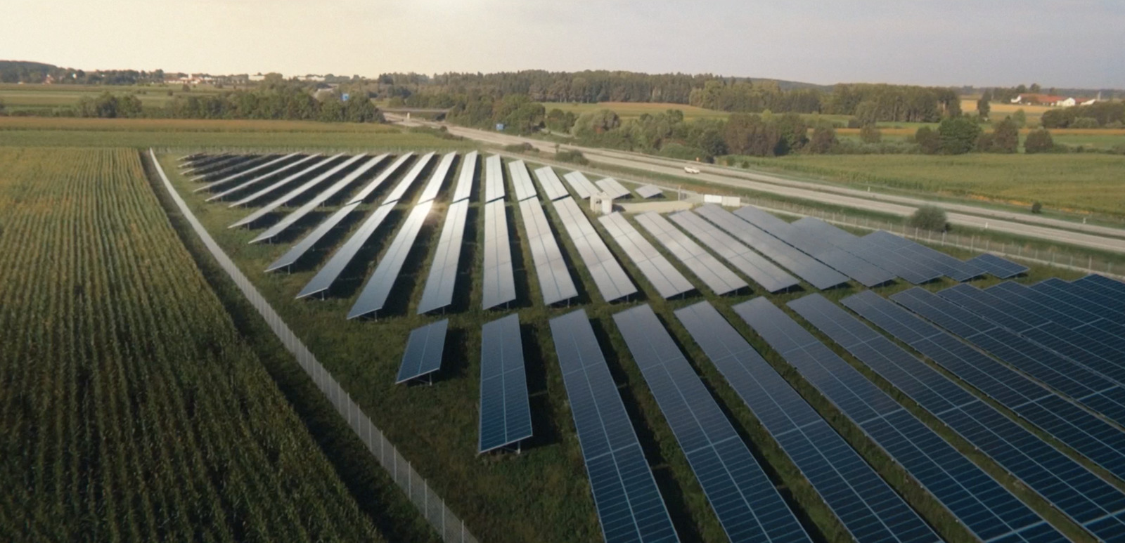 a large field of solar panels in a rural area