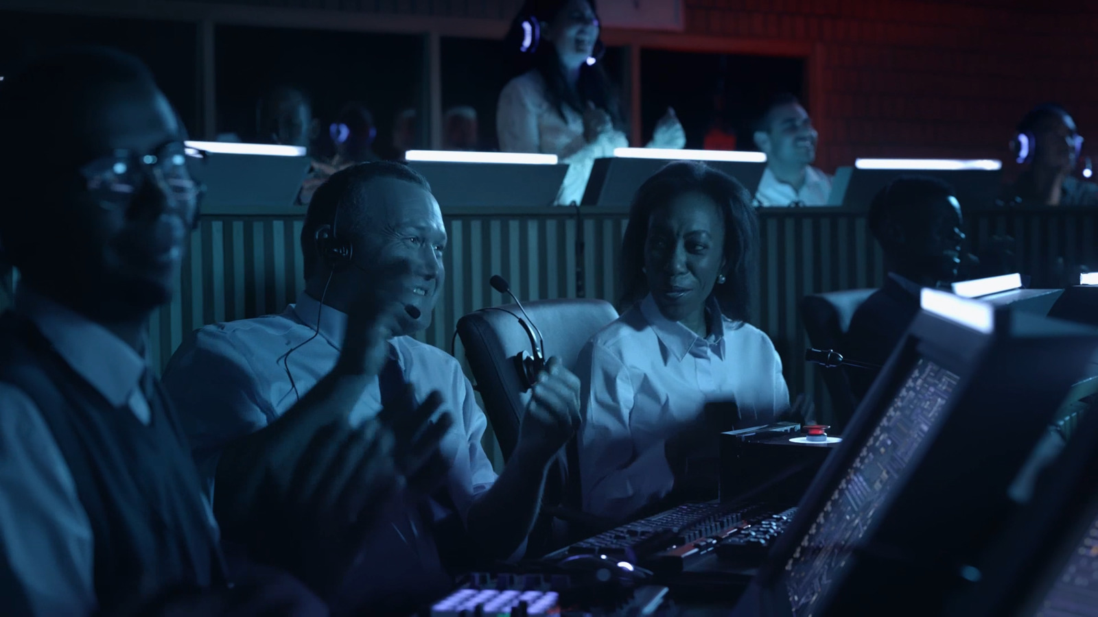 a group of people sitting in front of computers