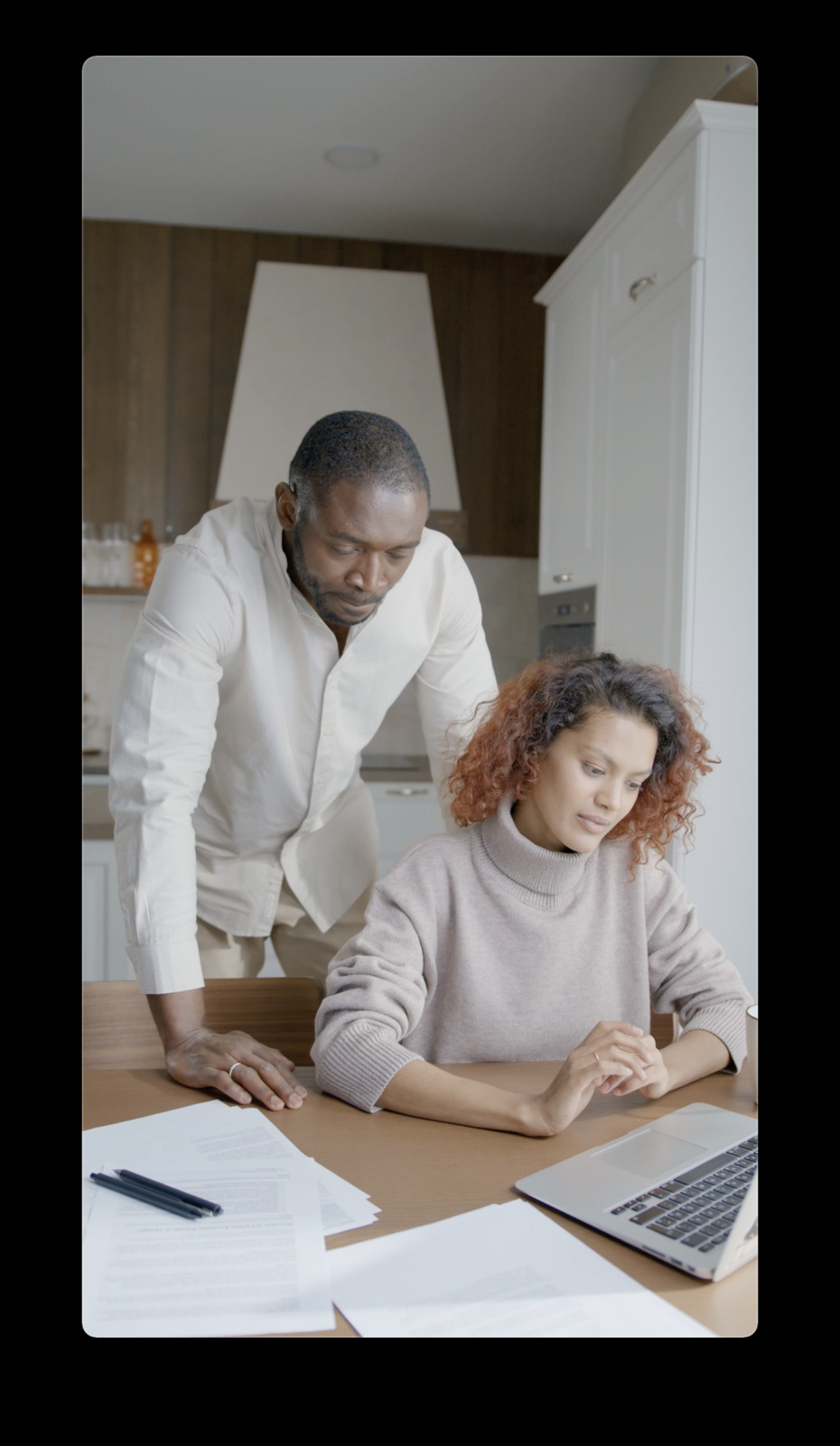 a man and a woman sitting at a kitchen table