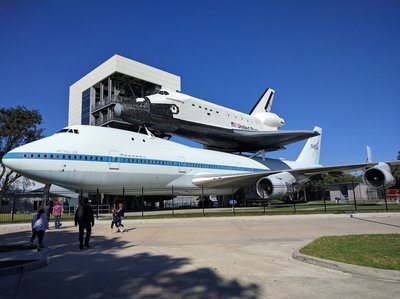 a space shuttle on top of a large airplane