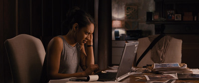 a woman sitting in front of a laptop computer