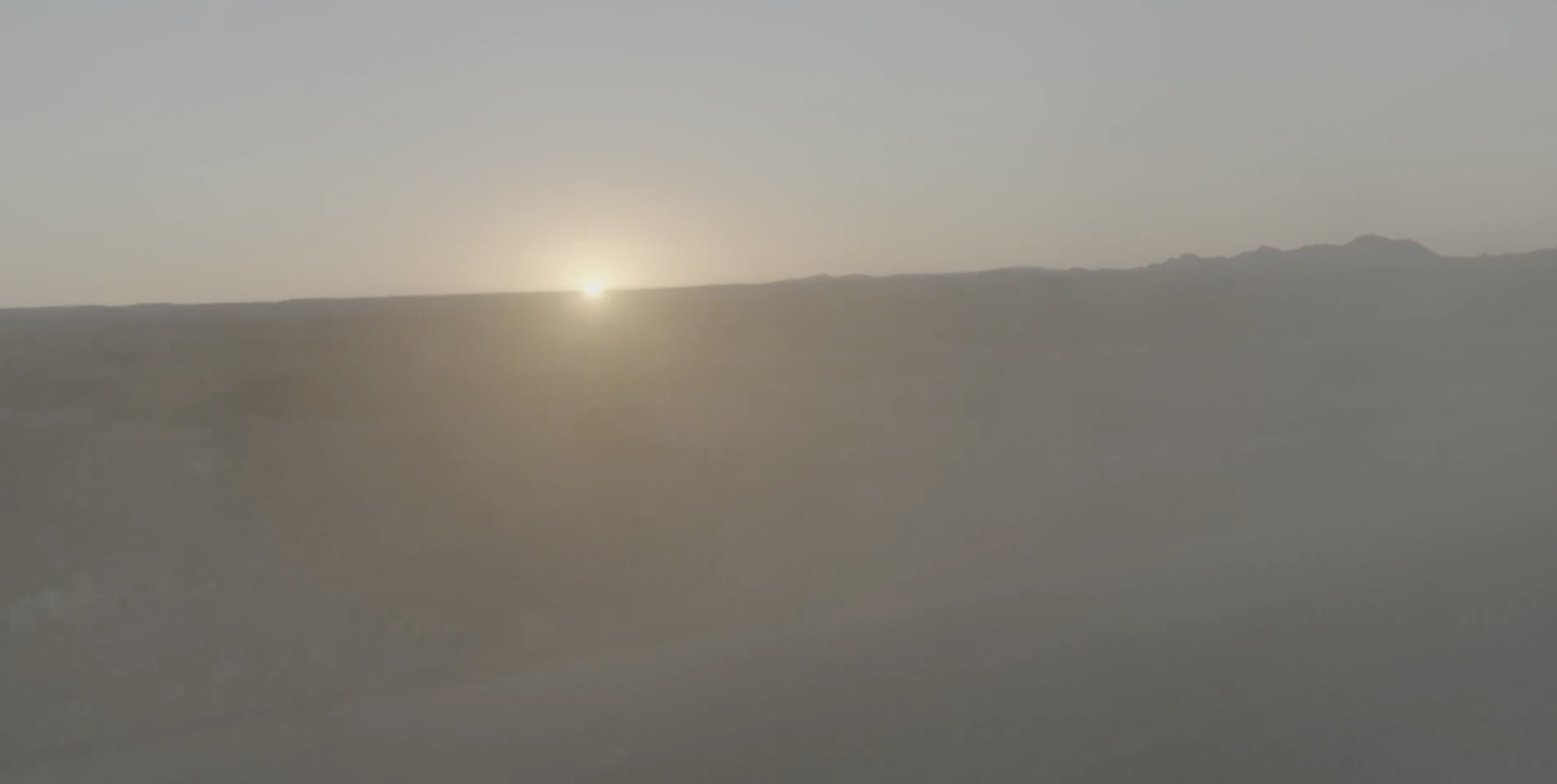 a person riding a surfboard on a foggy day