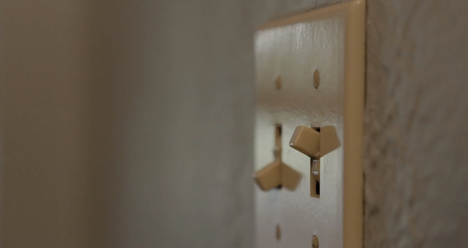 a close up of a light switch on a wall