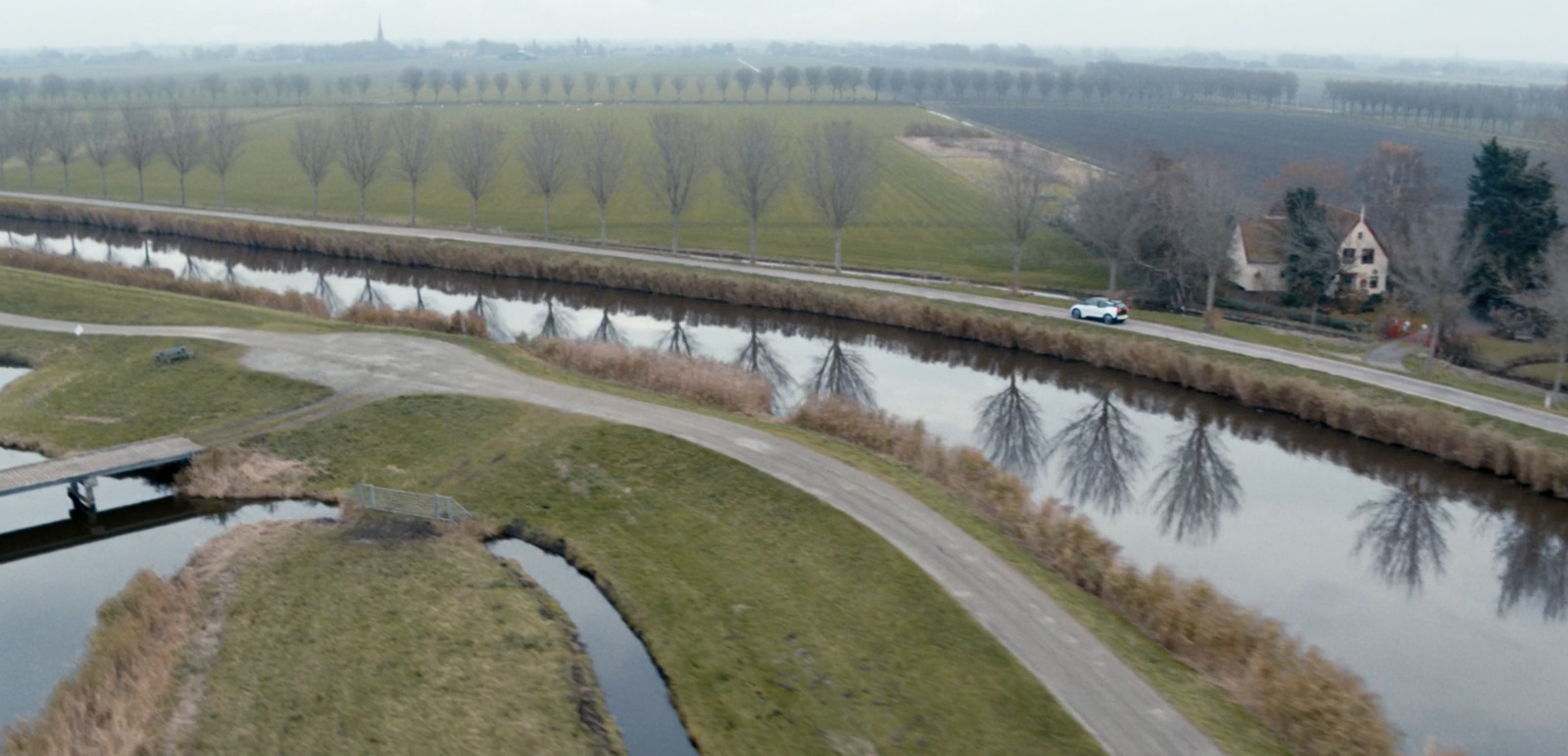 an aerial view of a river running through a rural area