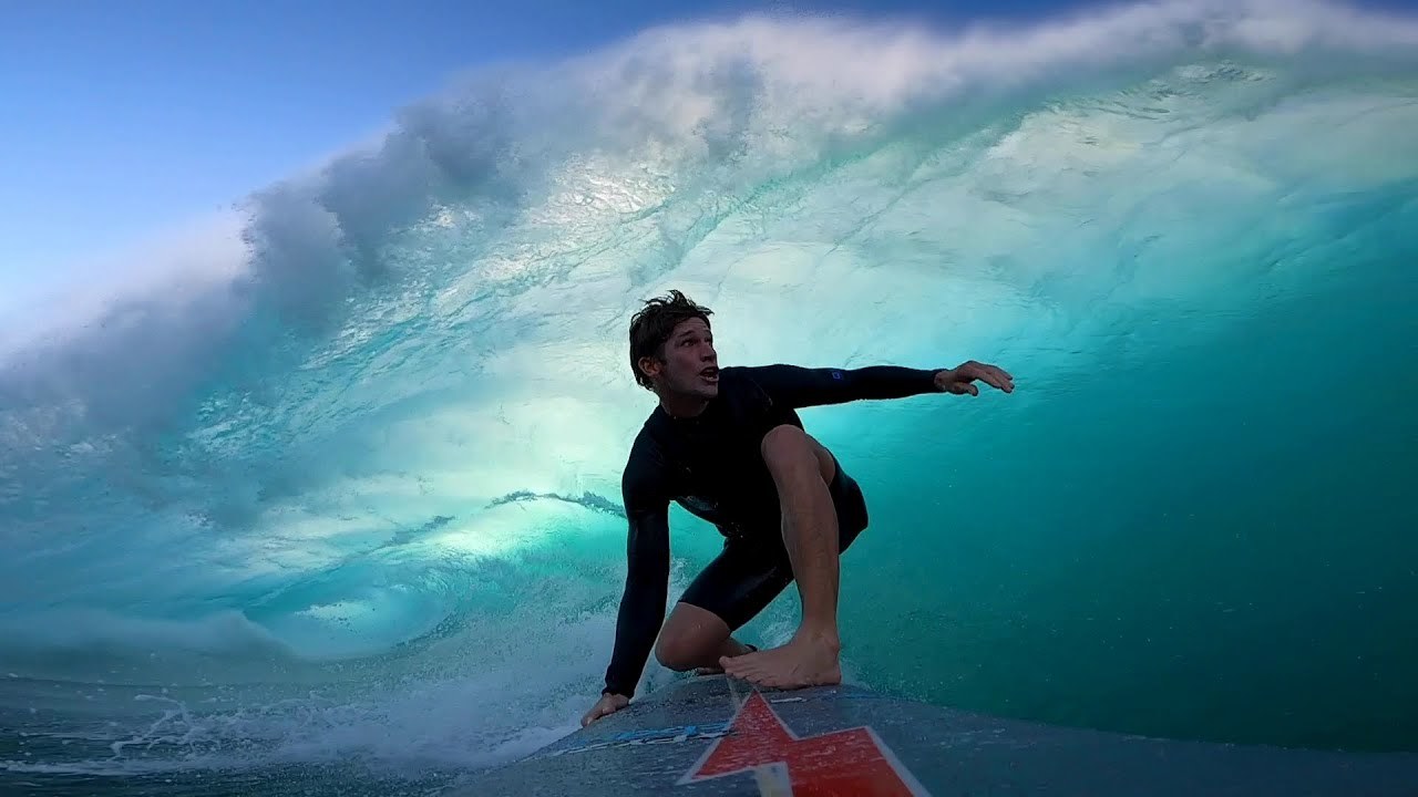 a man riding a wave on top of a surfboard