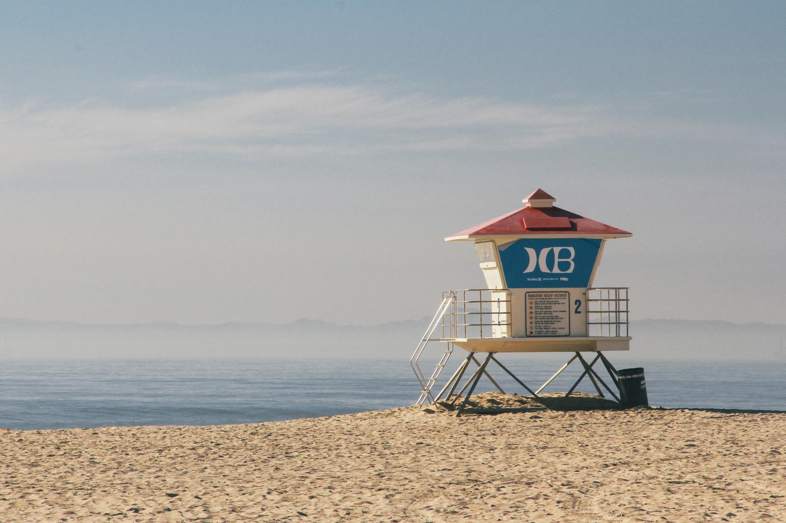 a lifeguard tower sitting on top of a sandy beach