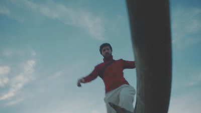 a man in a red shirt is flying through the air