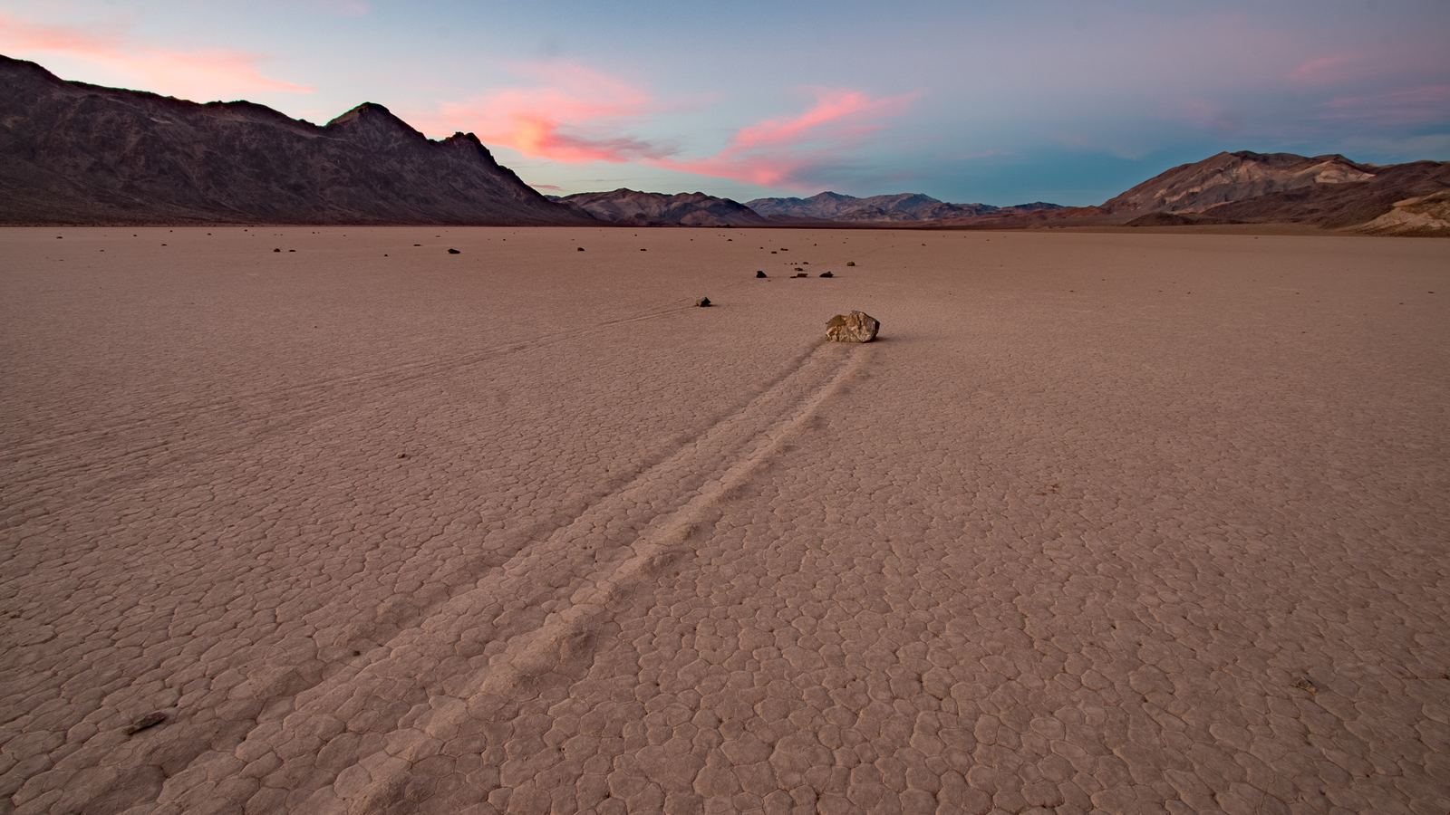 a desert landscape with mountains in the background