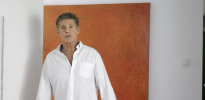 a man standing in front of a painting of himself