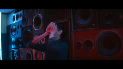 a man standing in front of a wall of speakers